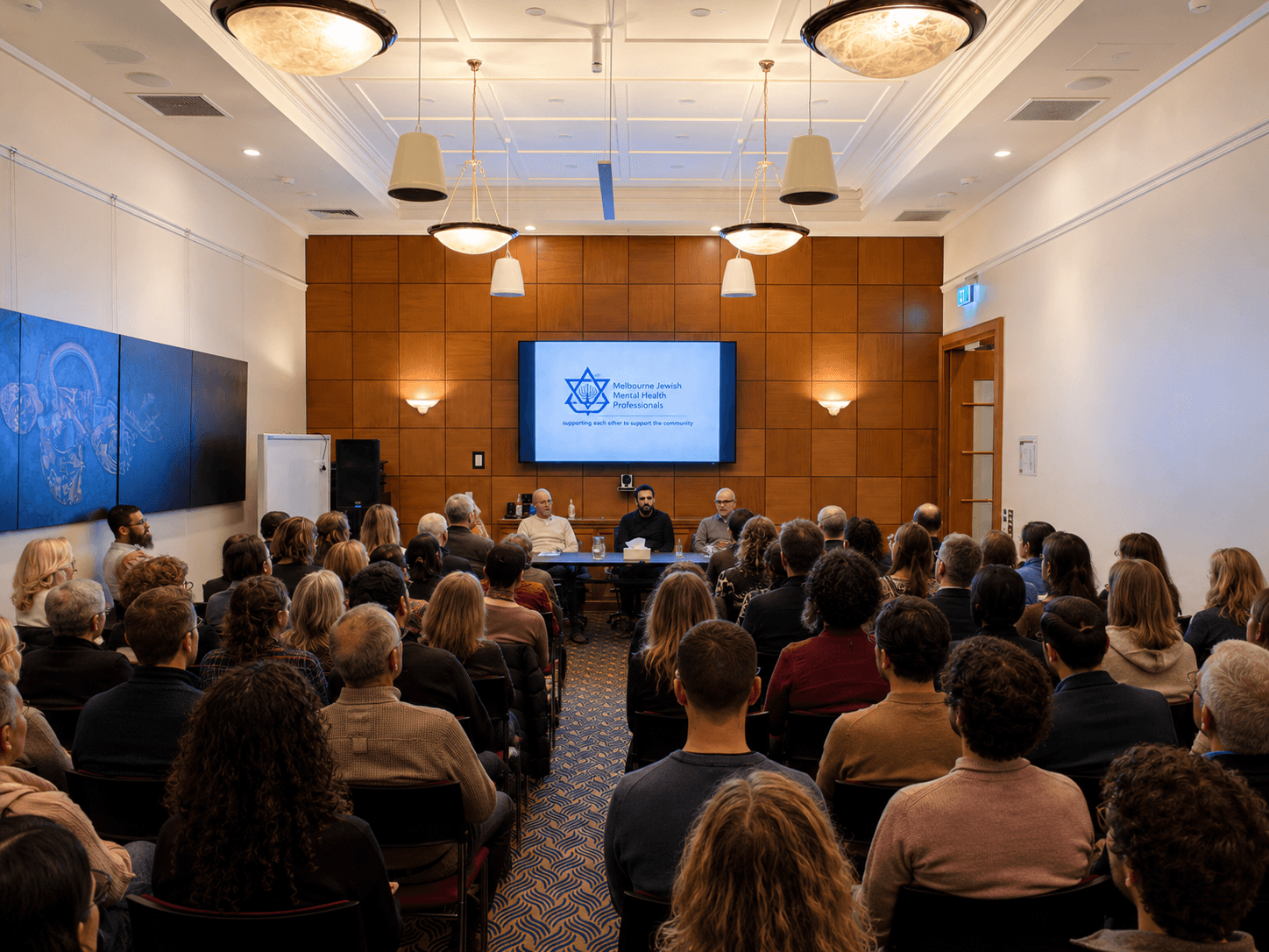 MJMHP community gathering — a room full of engaged mental health professionals at an MJMHP event